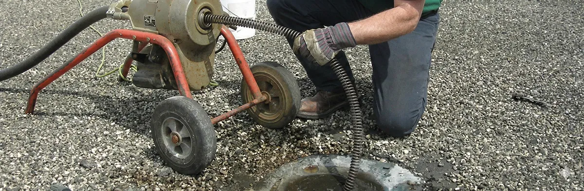 sewer rodding technician actively removing blockages from a sewer line in Denver, CO
